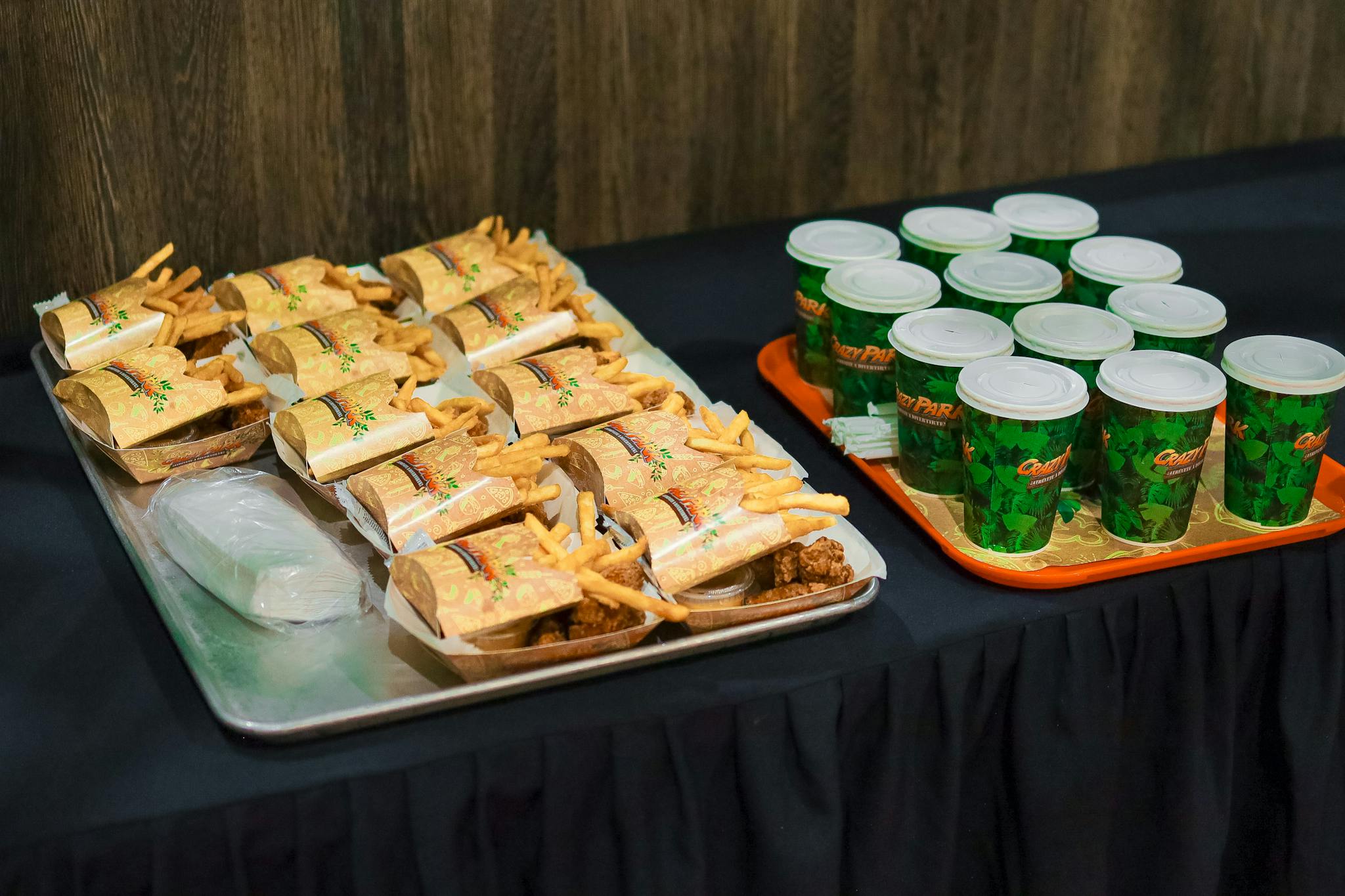 Assorted fast food including burgers, fries, and soft drinks on trays.